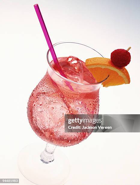fruit drink garnished with orange slice and raspberry - ginger ale stock pictures, royalty-free photos & images