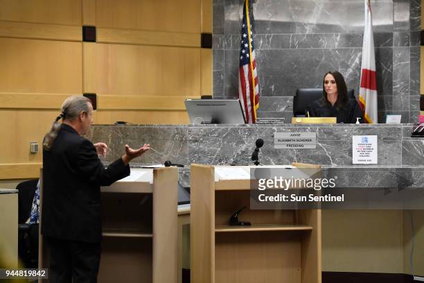 Broward County Public Defender Howard Finkelstein, left, speaks to Broward Circuit Judge Elizabeth Scherer during a hearing to determine who will...