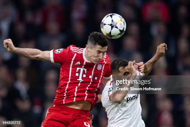 Robert Lewandowski of Muenchen jumps for a header with Gabriel Mercado of Sevilla during the UEFA Champions League Quarter Final second leg match...