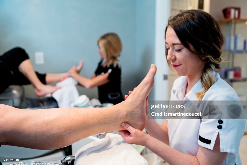 Senior couple having a pedicure in a beauty spa.