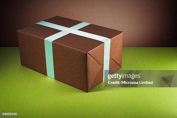 brown gift box - microzoa stock pictures, royalty-free photos & images