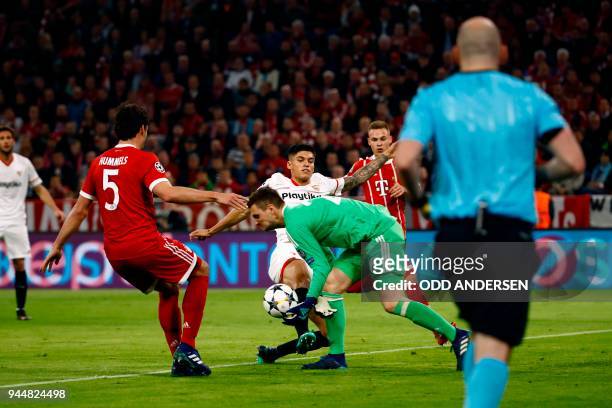 Sevilla's Argentinian midfielder Ever Banega kicks the ball in front of Bayern Munich's German goalkeeper Sven Ulreich during the UEFA Champions...