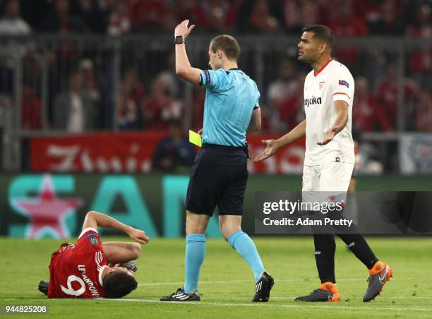 Referee William Collum gets ready to give a yellow card after Robert Lewandowski of Bayern Muenchen is fouled during the UEFA Champions League...