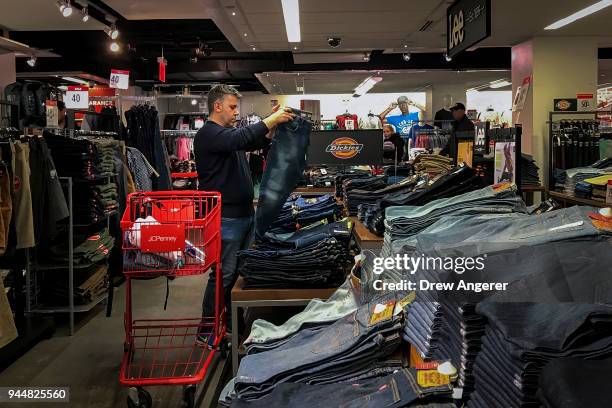 Man shops for jeans in a JCPenny store at the Manhattan Mall in the Herald Square neighborhood of Manhattan, April 11, 2018 in New York City. U.S....