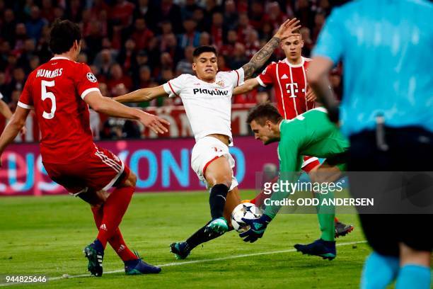 Sevilla's Argentinian midfielder Ever Banega kicks the ball in front of Bayern Munich's German goalkeeper Sven Ulreich during the UEFA Champions...