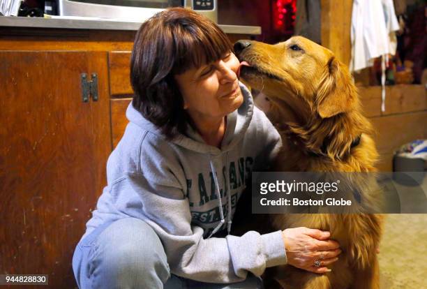 Pat Hamel gets a kiss from her dog Murphy inside her kitchen in Morrisville, VT on Jan. 11, 2016. Murphy bolted after a car accident and spent 559...