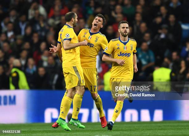 Mario Mandzukic of Juventus celebrates with teammate Giorgio Chiellini after scoring his sides second goal during the UEFA Champions League Quarter...