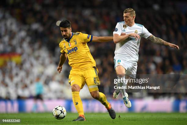 Sami Khedira of Juventus is challenged by Toni Kroos of Real Madrid during the UEFA Champions League Quarter Final Second Leg match between Real...