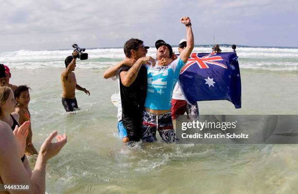 Taj Burrow of Australia celebrates his victory with coach Johnny Gannon of Australia at the Billabong Pipeline Masters on December 15, 2009 in...