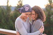 Beautiful woman battling cancer hugs her sister tightly