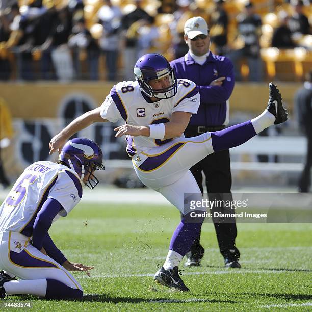 Placekicker Ryan Longwell of the Minnesota Vikings practices kicks under the hold of punter Chris Kluwe prior to a game on October 25, 2009 against...
