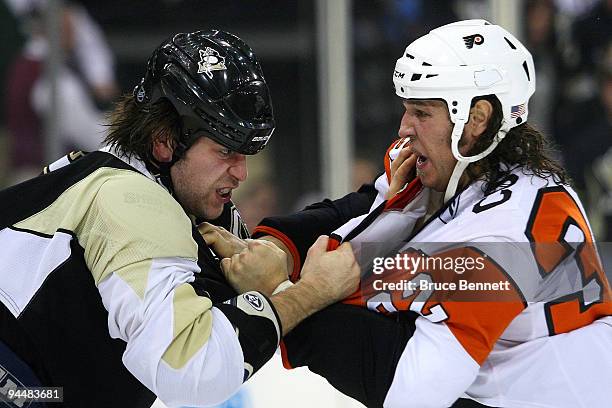 Riley Cote of the Philadelphia Flyers and Eric Godard of the Pittsburgh Penguins square off during a first period fight at the Mellon Arena on...