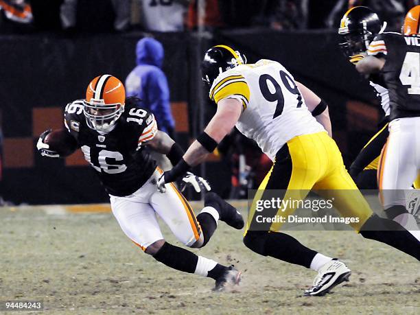 Quarterback Joshua Cribbs of the Cleveland Browns carries the ball as defensive lineman Brett Keisel of the Pittsburgh Steelers approaches during a...