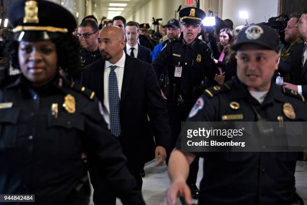 Mark Zuckerberg, chief executive officer and founder of Facebook Inc., center, walks through the Rayburn House Office building after a House Energy...