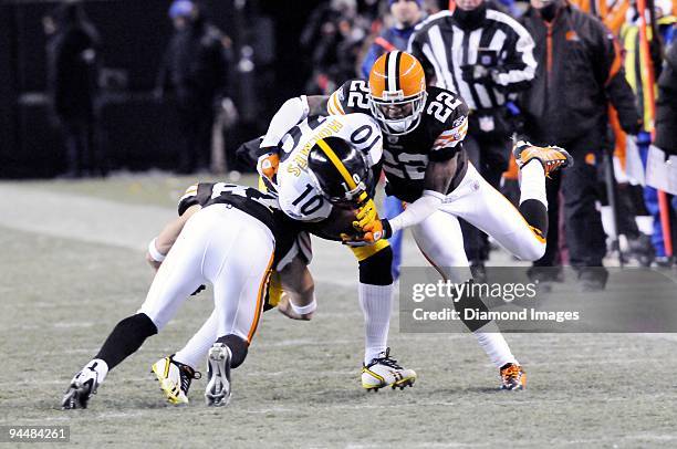 Wide receiver Santonio Holmes of the Pittsburgh Steelers is tackled by defensive backs Brandon McDonald and Mike Furrey of the Cleveland Browns...