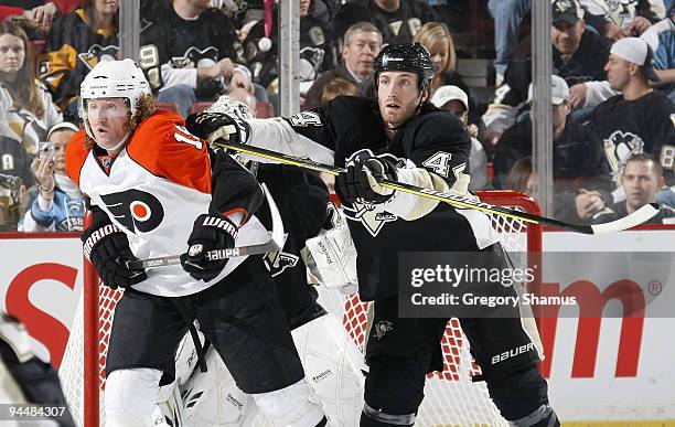 Brooks Orpik of the Pittsburgh Penguins pushes Scott Hartnell of the Philadelphia Flyers on December 15, 2009 at Mellon Arena in Pittsburgh,...