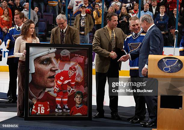 Ron Sutter of the Calgary Flames organization presents Brett Hull with a collage of images from his time with the Flames on Brett Hull Hall of Fame...