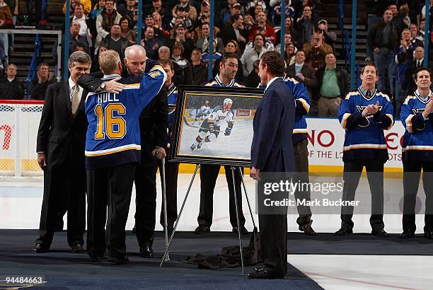 Brett Hull, formerly of the St. Louis Blues, hugs John Davidson of the St. Louis Blues organization during the Brett Hull Hall of Fame night before a...