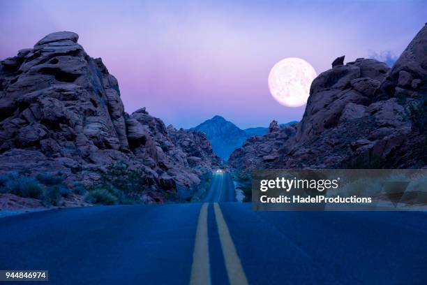 road trip at twilight - nevada road stock pictures, royalty-free photos & images