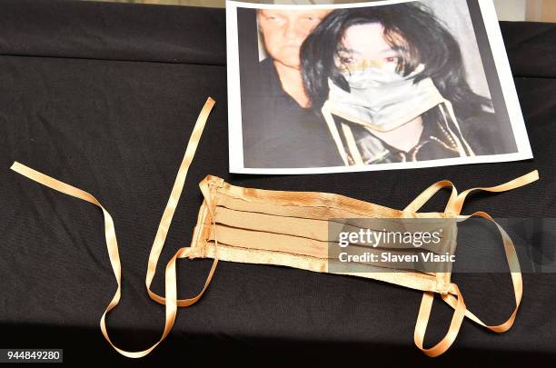 Michael Jackson's owned and used gold surgical face mask that bears his face makeup on the inside at display at "Rock & Roll Pop Culture Auction...