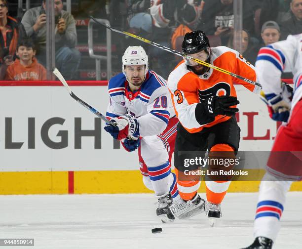 Radko Gudas of the Philadelphia Flyers battles for the puck against Chris Kreider of the New York Rangers on April 7, 2018 at the Wells Fargo Center...