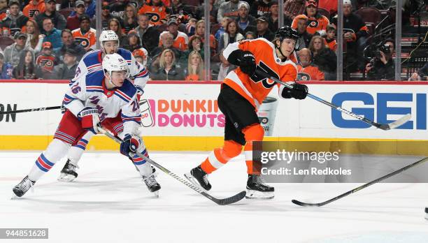 Oskar Lindblom of the Philadelphia Flyers completes a pass against Jimmy Vesey and Ryan Sproul of the New York Rangers on April 7, 2018 at the Wells...