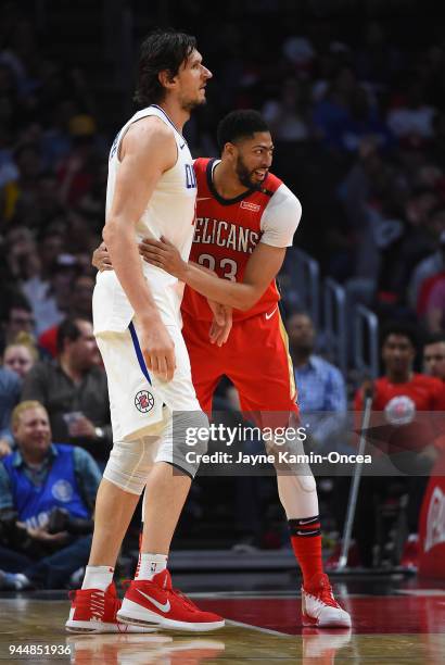 Anthony Davis of the New Orleans Pelicans and Boban Marjanovic of the Los Angeles Clippers laugh on the court in the game at Staples Center on April...