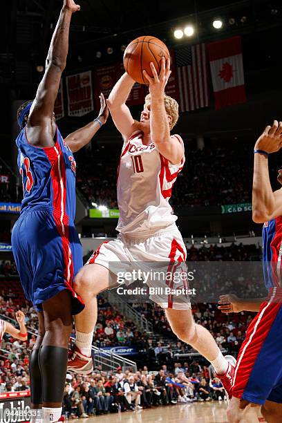 Chase Budinger of the Houston Rockets shoots the ball over Kwame Brown of the Detroit Pistons on December 15, 2009 at the Toyota Center in Houston,...