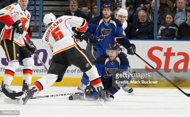 Andy McDonald of the St. Louis Blues attempts to block the shot of Mark Giordano of the Calgary Flames on December 15, 2009 at Scottrade Center in...