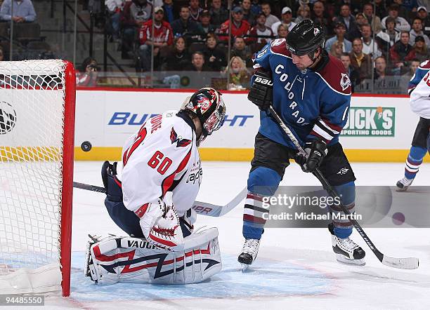 Darcy Tucker of the Colorado Avalanche deflects the puck against goaltender Jose Theodore of the Washington Capitals at the Pepsi Center on December...