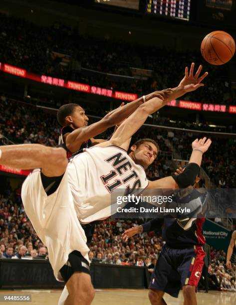 Brook Lopez of the New Jersey Nets battles for the loose ball with Jamario Moon of the Cleveland Cavaliers on December 15, 2009 at The Quicken Loans...