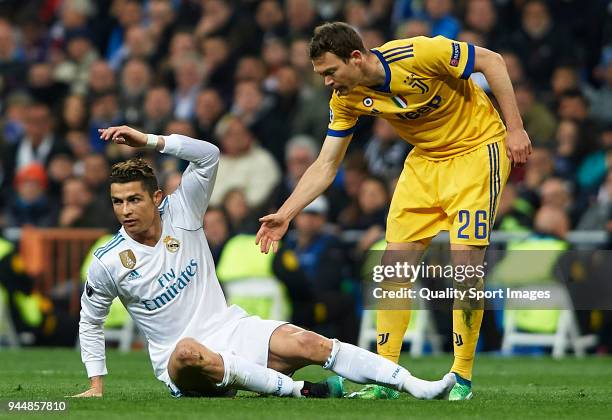 Cristiano Ronaldo of Real Madrid reacts to Stephan Lichsteiner of Juventus during the UEFA Champions League Quarter Final Second Leg match between...