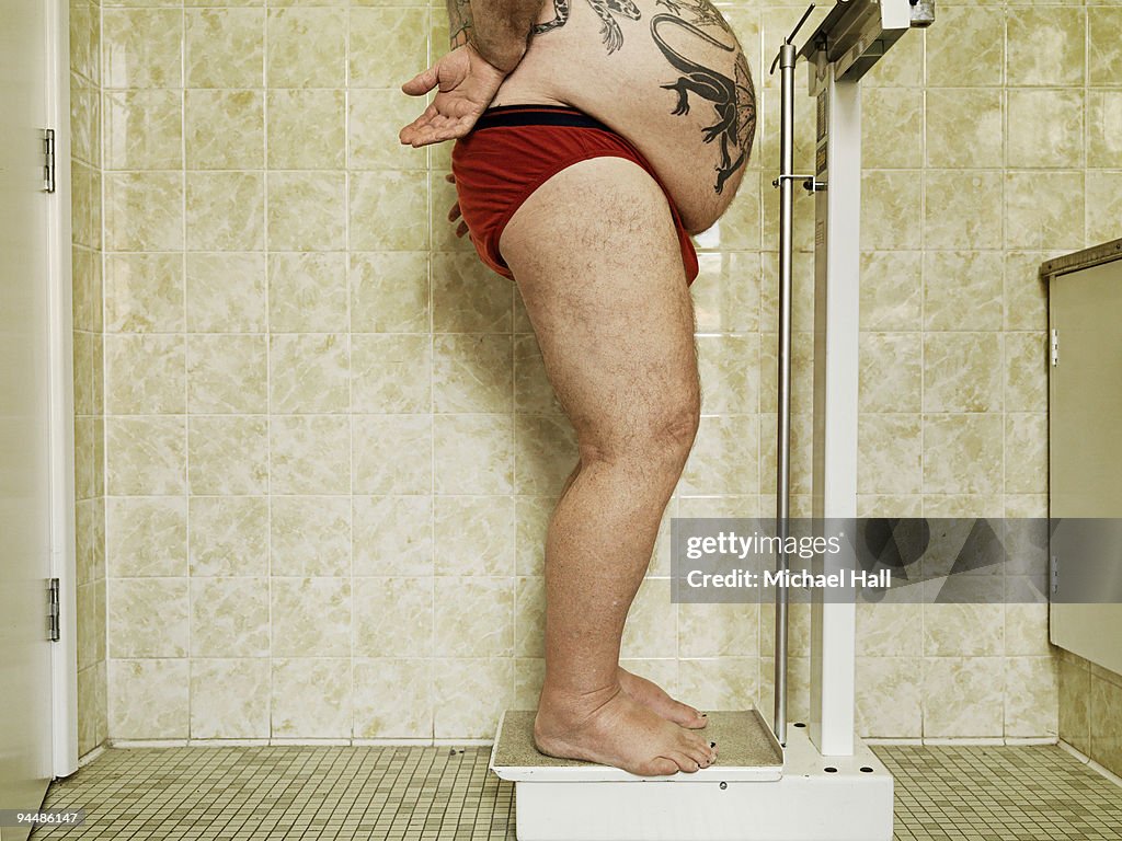 Man weighing himself