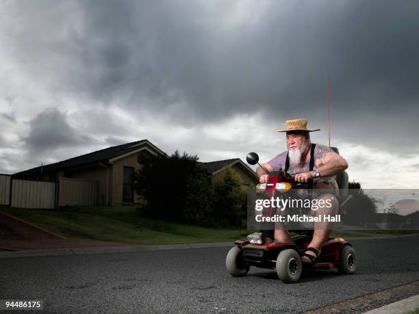 man on mobility scooter - mobility scooters stock pictures, royalty-free photos & images