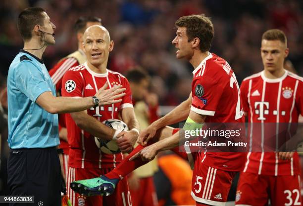 Arjen Robben of Bayern Muenchen and Thomas Mueller of Bayern Muenchen confront referee William Collum during the UEFA Champions League Quarter Final...