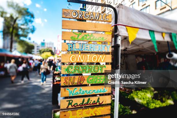 signs for vegetables and greens for sale - union square new york city stock pictures, royalty-free photos & images