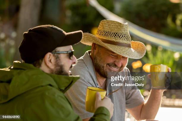 happy smiling mid adult man drinking coffee - jasondoiy imagens e fotografias de stock