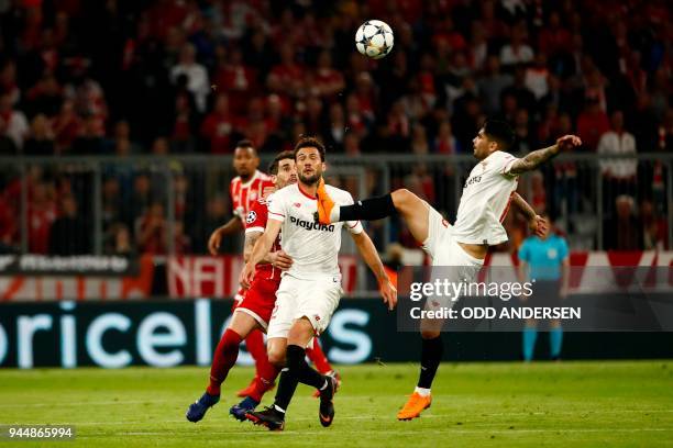 Sevilla's Spanish defender Sergio Escudero vies with teammate Argentinian midfielder Joaquin Correa during the UEFA Champions League quarter-final...