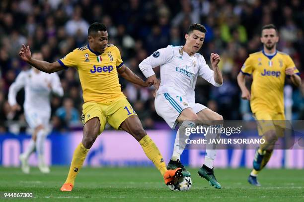 Juventus' Brazilian defender Alex Sandro vies with Real Madrid's Portuguese forward Cristiano Ronaldo during the UEFA Champions League quarter-final...