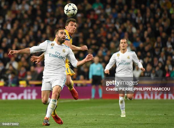 Real Madrid's Spanish defender Dani Carvajal vies with Juventus' Croatian forward Mario Mandzukic during the UEFA Champions League quarter-final...