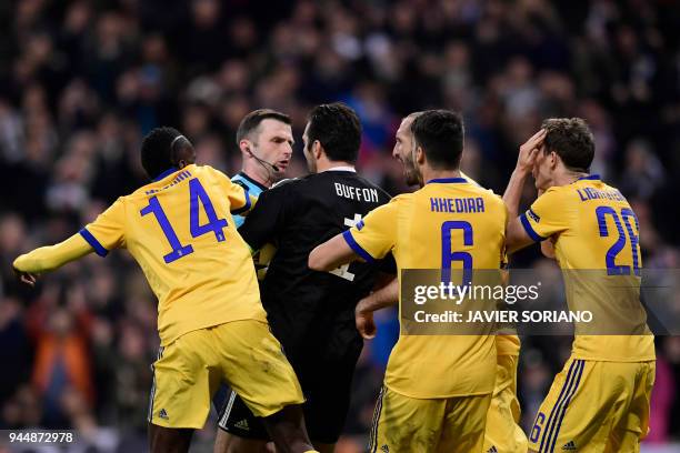 Juventus' Italian goalkeeper Gianluigi Buffon argues with British referee Michael Oliver during the UEFA Champions League quarter-final second leg...