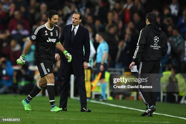 Massimiliano Allegri, Head Coach of Juventus speaks to Gianluigi Buffon of Juventus as he leaves the pitch after recieving a red card during the UEFA...
