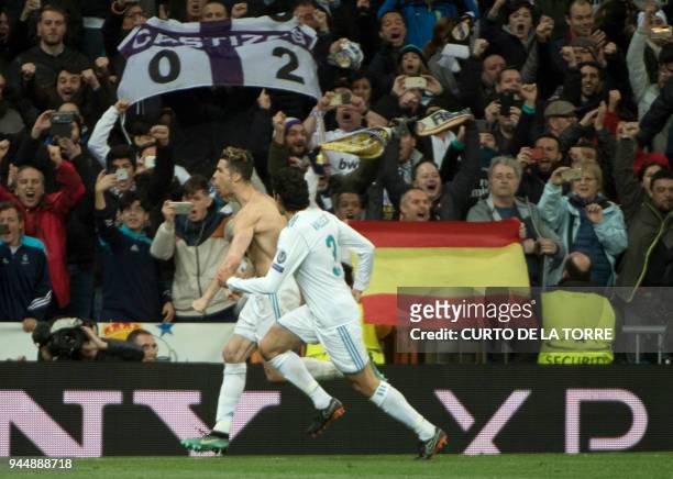 Real Madrid's Portuguese forward Cristiano Ronaldo celebrates after shooting a penalty kick to score a goal during the UEFA Champions League...