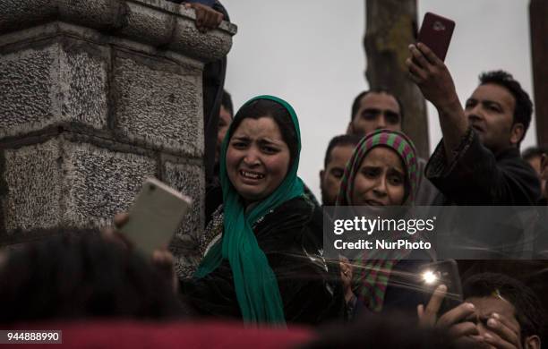 Kashmiri women cry during the funeral procession of Sharjeel Sheikh, a civilian who was shot dead by Indian government forces during clashes near the...