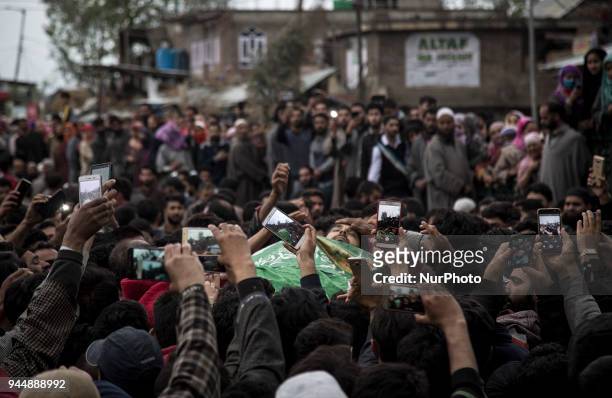 Kashmiri civilians click pictures of the body of Sharjeel Sheikh, a civilian who was shot dead by Indian government forces during clashes near the...