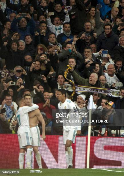 Real Madrid's Portuguese forward Cristiano Ronaldo celebrates a goal after shooting a penalty kick during the UEFA Champions League quarter-final...