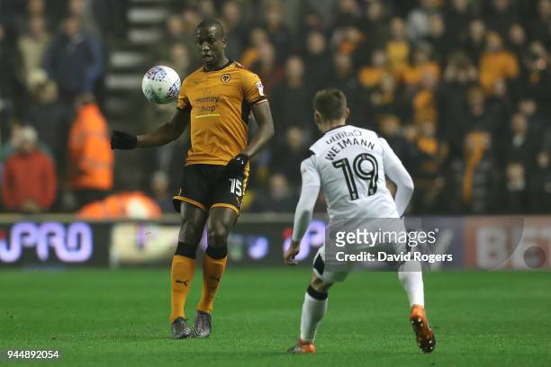 Willy Boly of Wolverhampton Wanderers looks to take on Andreas Weimann of Derby County during the Sky Bet Championship match between Wolverhampton...