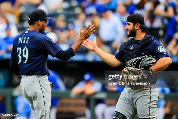 Edwin Diaz and David Freitas of the Seattle Mariners celebrate the win over the Kansas City Royals after the game at Kauffman Stadium on April 11,...