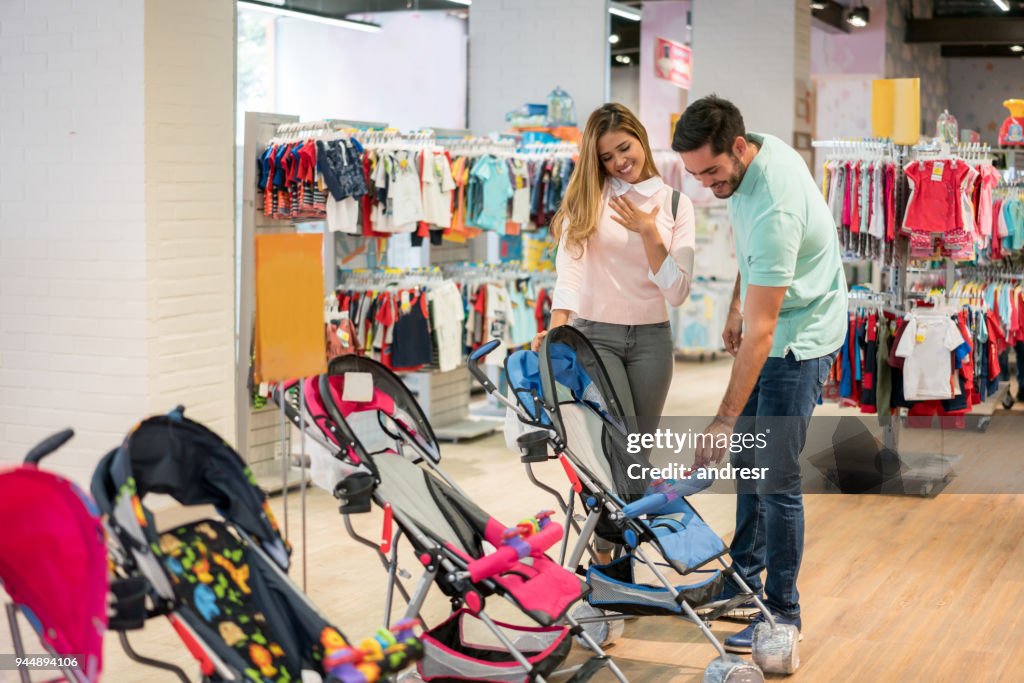 Casual couple shopping for a stroller at a store