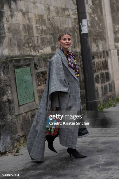 Fashion blogger Janka Polliani wears Balenciaga boots, bag, skirt and coat and a Lovechild top day 4 of Paris Womens Fashion Week Spring/Summer 2018,...